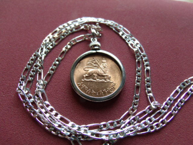 Read more about the article Haile Sellasie Lion of Judah Coin Pendant on a 28″ Silver Link Style Chain. 23mm