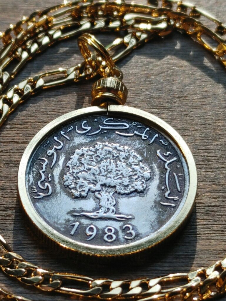 Read more about the article 1983 Tunisia Scarce Olive Tree Millieme Coin Pendant on A 24″ 18KGF Chain.