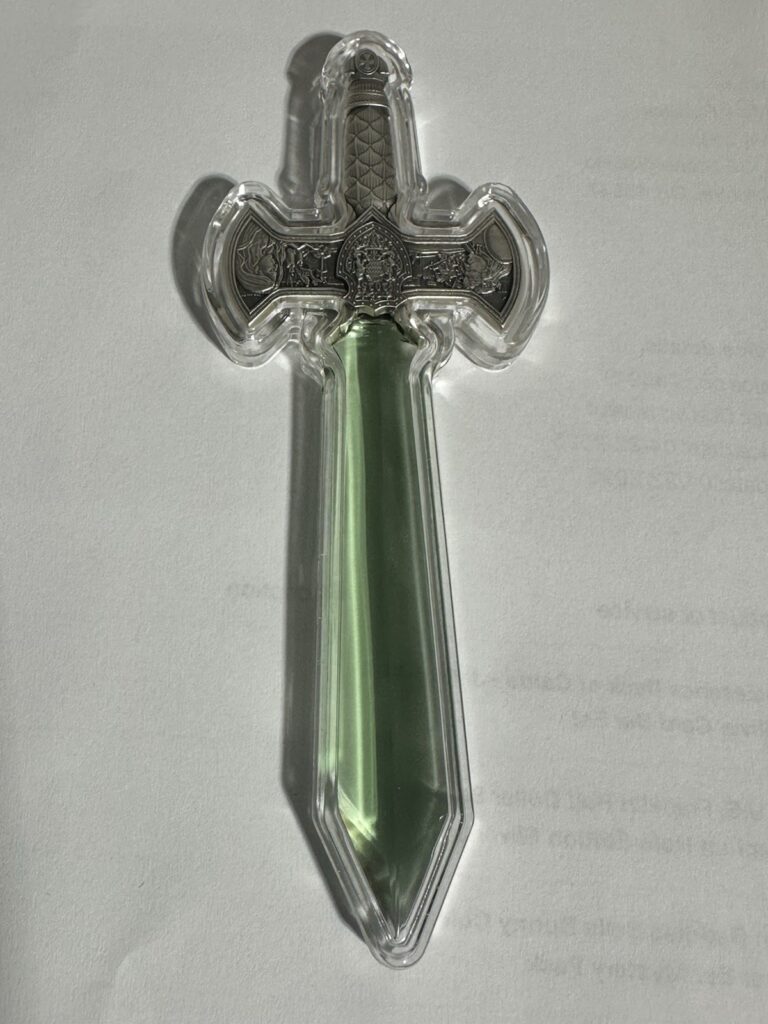Read more about the article 2025 Chad Excalibur 1 Oz Silver Sword Shaped Coin With Green Crystal Blade