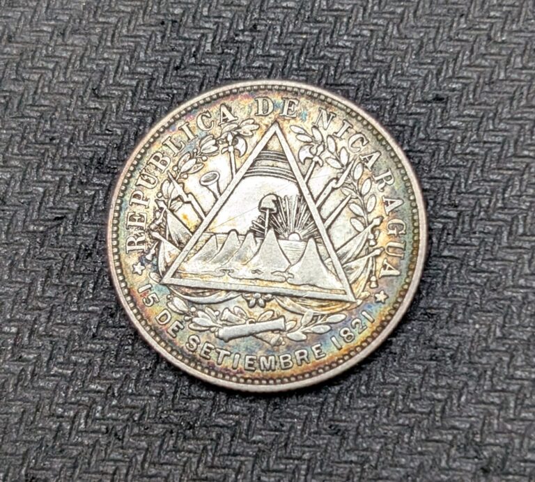 Read more about the article 1887 H Nicaragua Silver 20 Centavos Rainbow Toned From Album XF KM#7