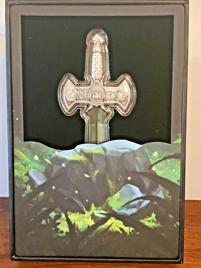 Read more about the article 2025 Chad Excalibur 1 Oz Silver Sword Shaped Coin With Green Crystal Blade