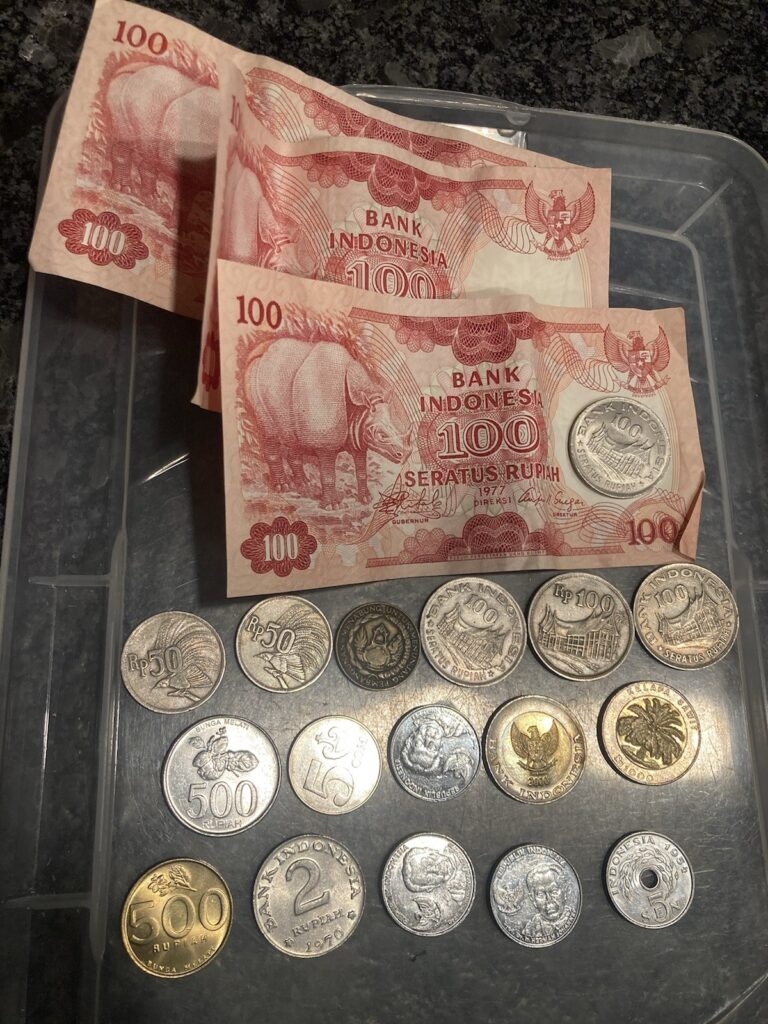 Read more about the article Indonesia Rupiah Lot. Collection Of Indonesian coins And 3 100 Rupiah Bills {L)