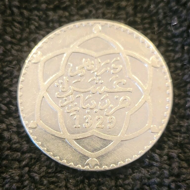 Read more about the article Morocco 1 Rial/10 Dirhams 1911/1329 90% silver NGC Y25